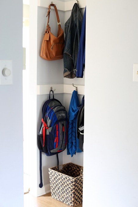 coats and backpacks hanging in the new coat storage space