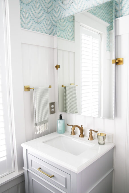 Half Bath with Large Mirror and Brass Towel Holder