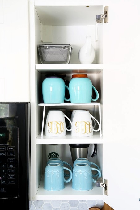 Awesome tips and tricks for organizing a small kitchen-- and proof that small kitchens can be beautiful too! Click through to the post for her amazing organization tips!