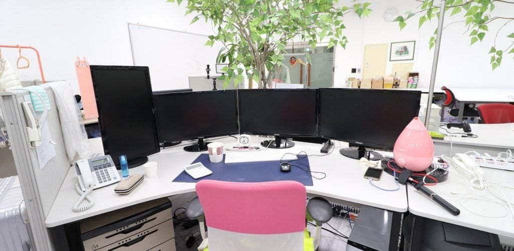 Messy office desk with computer and office chair