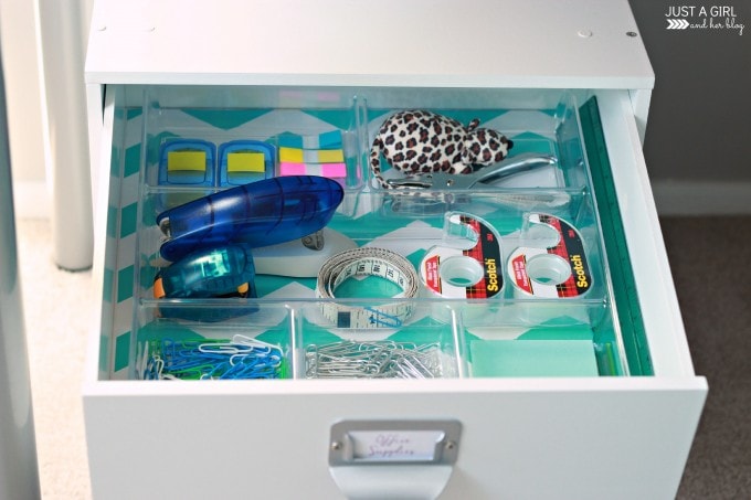 an open drawer with office supplies