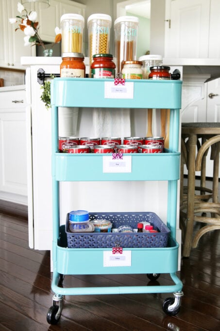 Rolling cart holding organized pantry items