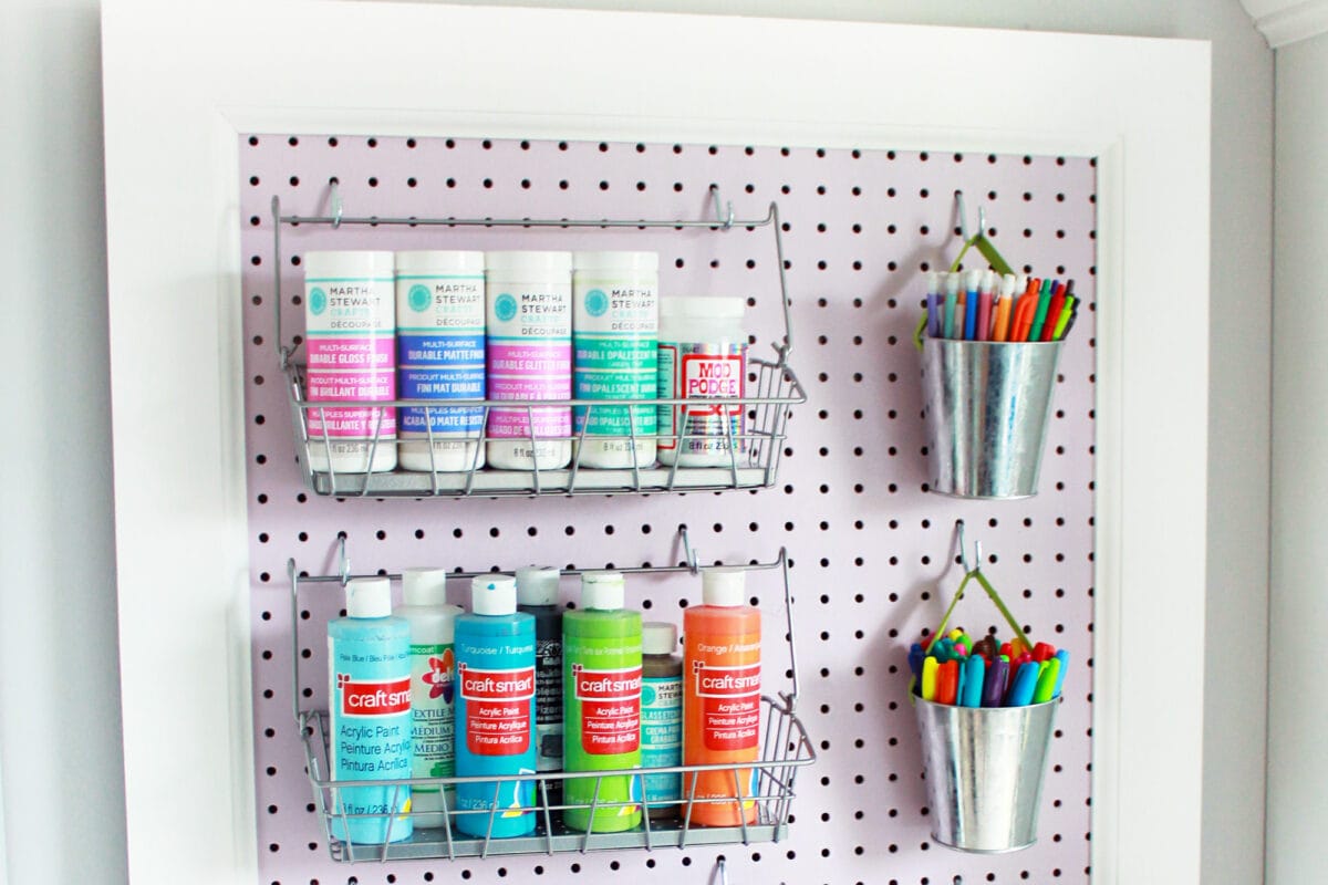 Lavender pegboard holding organized craft supplies