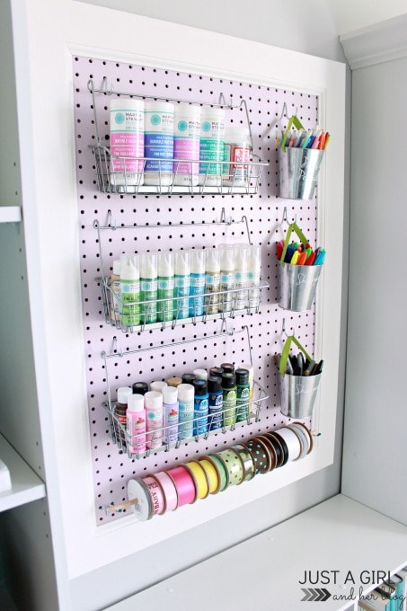 a pegboard holding craft supplies