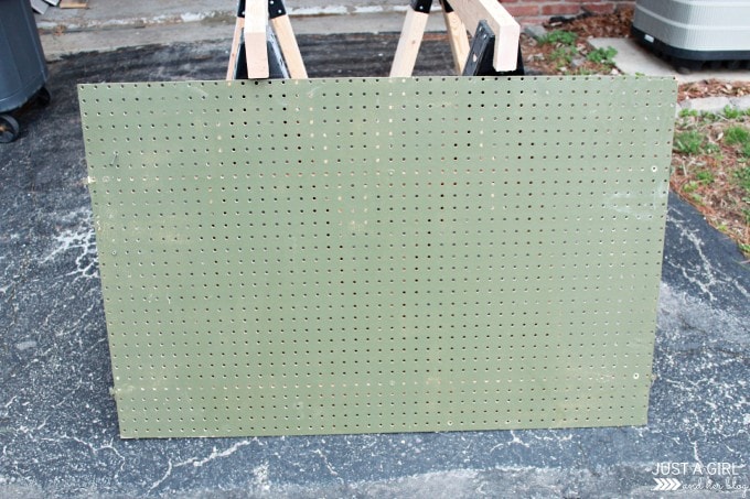 old green pegboard that is dusty and in need of a makeover