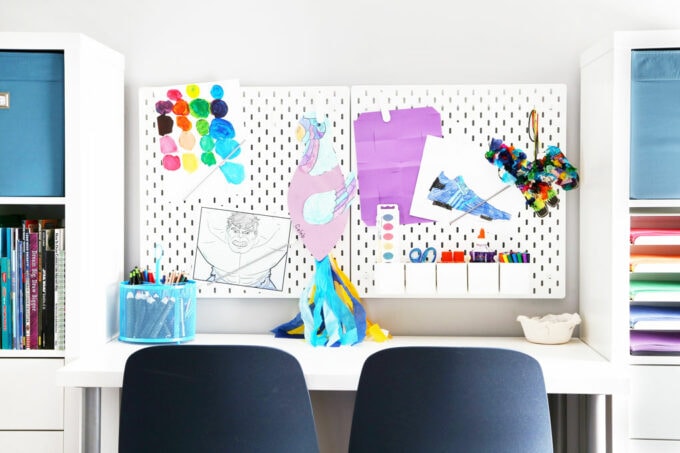 pegboards with kids' artwork and craft supplies