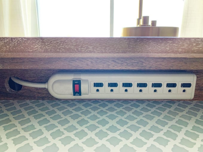 Power strip attached to nightstand in drawer for diy charging station