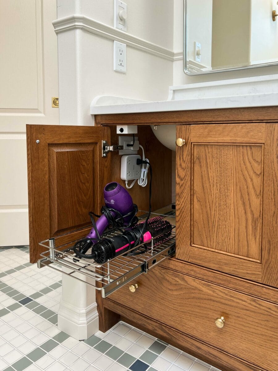 Pull out drawer under the bathroom sink for hair products with plug