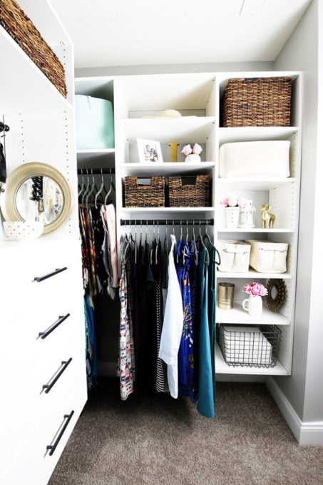 Wire Bin Holding Sheets in Organized Primary Bedroom Closet