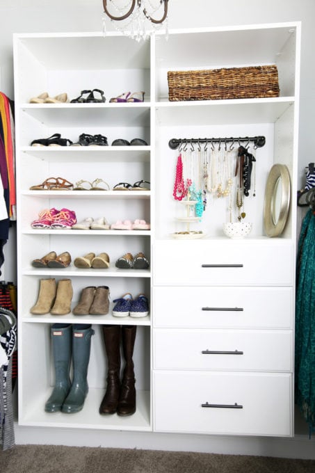 Organized shoes lined up on shelves in a primary closet