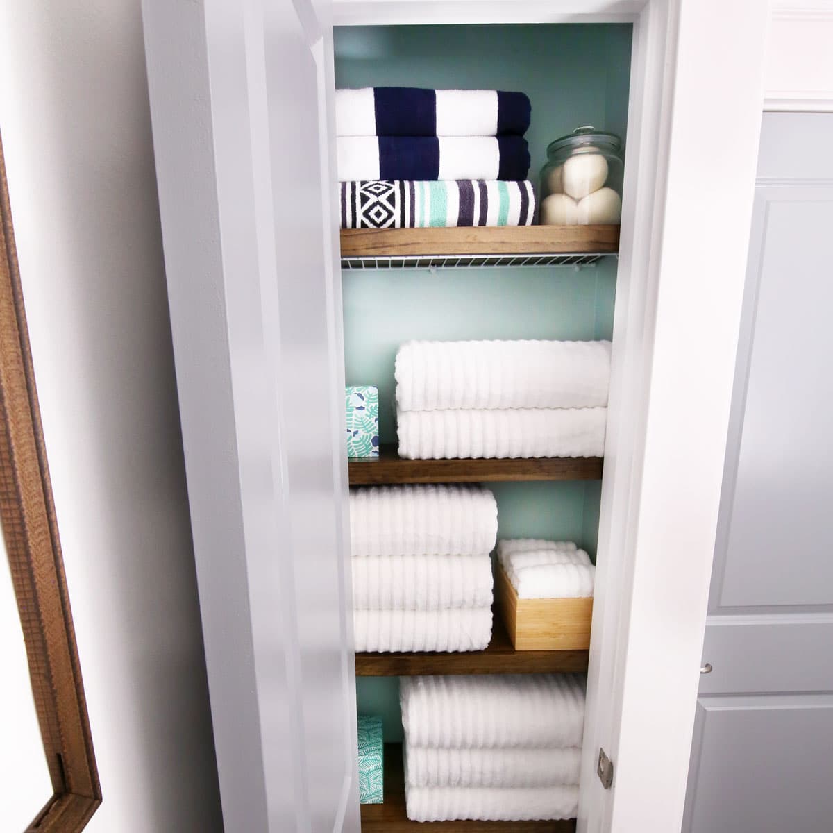 Small Linen Closet Organization with Neatly Folded Towels