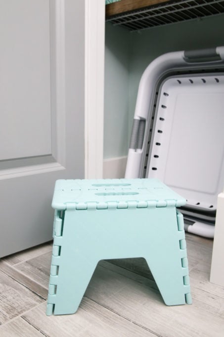 Collapsible Stool in a Small Linen Closet, Used to Maintain an Organized Laundry Room