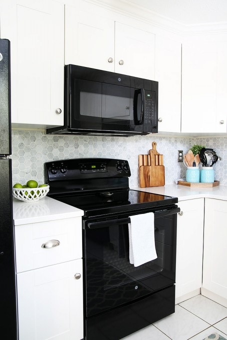 Awesome tips and tricks for organizing a small kitchen-- and proof that small kitchens can be beautiful too! Click through to the post for her amazing organization tips!