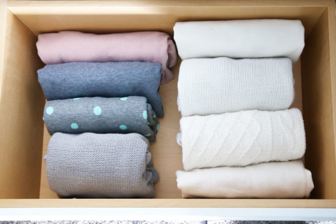 Sweaters folded in an organized closet drawer, closet ideas