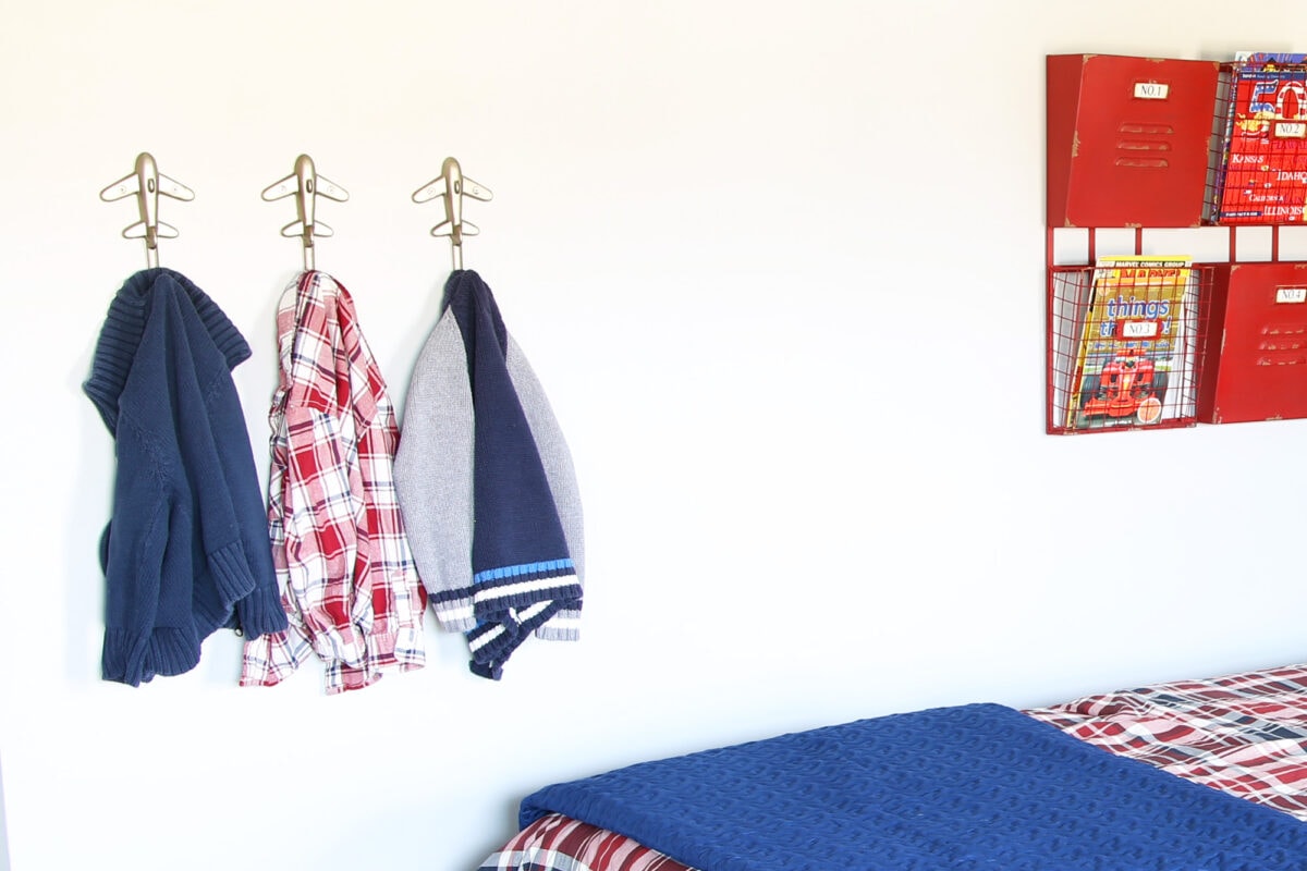 Sweaters hanging on hooks in an organized kids' room