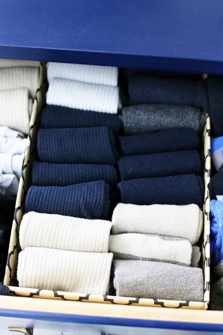 Shoeboxes wrapped in pretty wrapping paper, used to organize a sock drawer