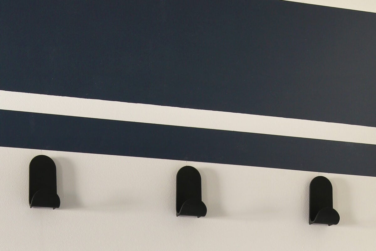 3 hooks installed to create a hat wall in a boys' bedroom