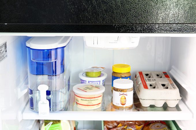 closeup of the top shelf in the fridge after organizing