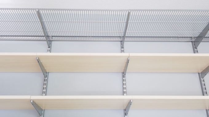 Platinum vented shelves and solid sand shelves from an Elfa shelving unit from The Container Store