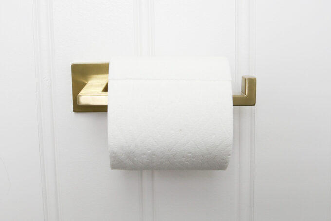 Toilet Paper Roll with Brass Holder in a Pretty Powder Room