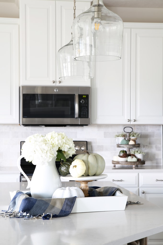 Home- Kitchen island pendant lights, hallway pendant lights, lanterns, changing light fixtures, kitchen lighting, hallway lighting, design mistakes, glass pendant lights, white kitchen, clear glass lighting, kitchen island with chunky corbels and trim work, fall kitchen decor