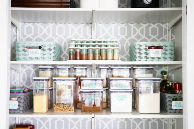 Organized pantry with decanted baking items, pasta, and spices