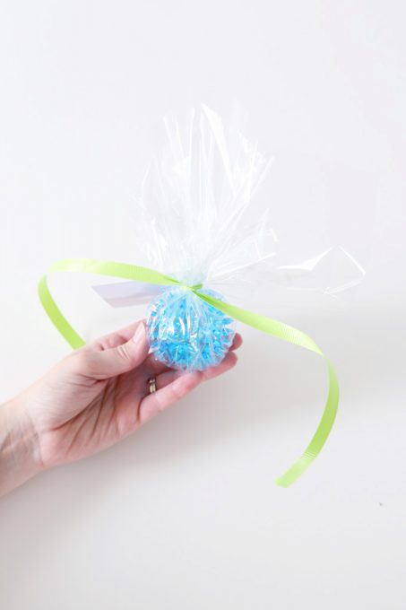 ribbon and card tied around the bag with the bouncy ball