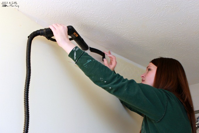 Abby holding the steamer on the wallpaper border