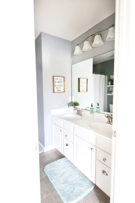 Guest Bathroom with White Vanity and Aqua Bath Mat