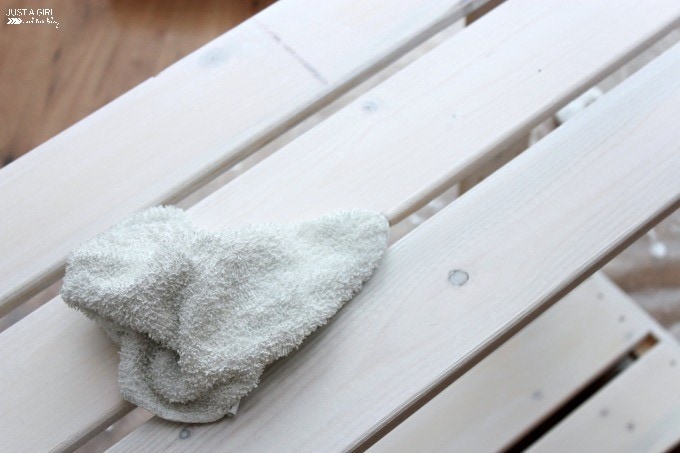 close up of painted shelf with a white rag