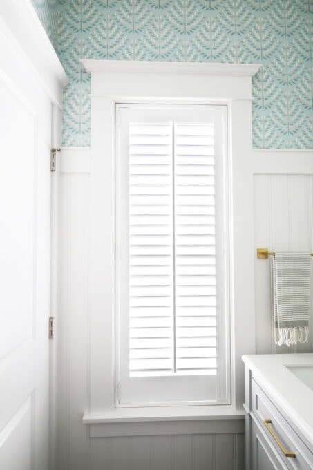 Window with Wood Shutter and Craftsman Style Trim in a Small, Pretty Powder Room