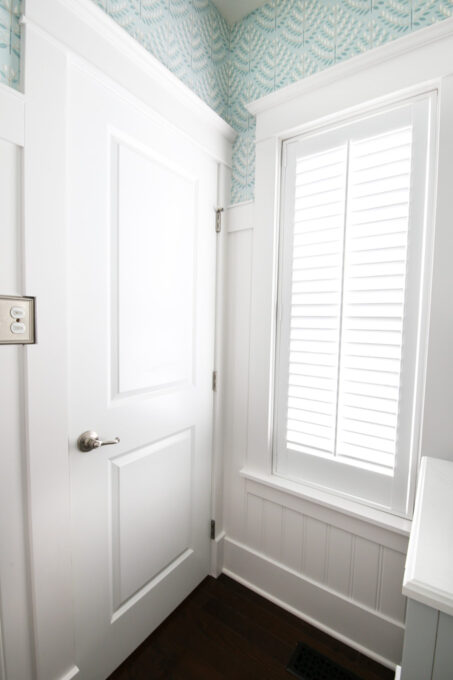 Door and Window with Craftsman Style Trim in a Beautifully Transformed Half Bath