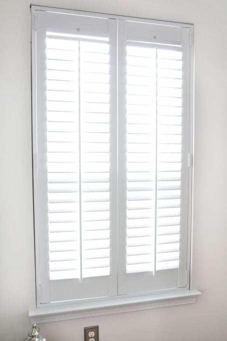 finished window with shutters installed and the blinds opened