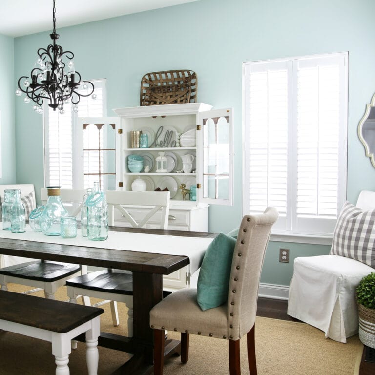 Aqua dining room with white wood shutters